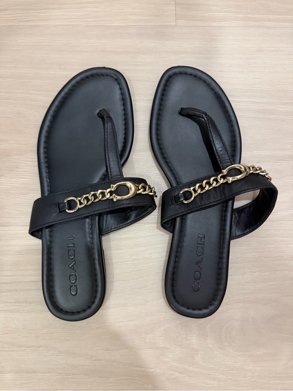 Coach Black Leather Toe-Post Sandals with Gold Chain Accent